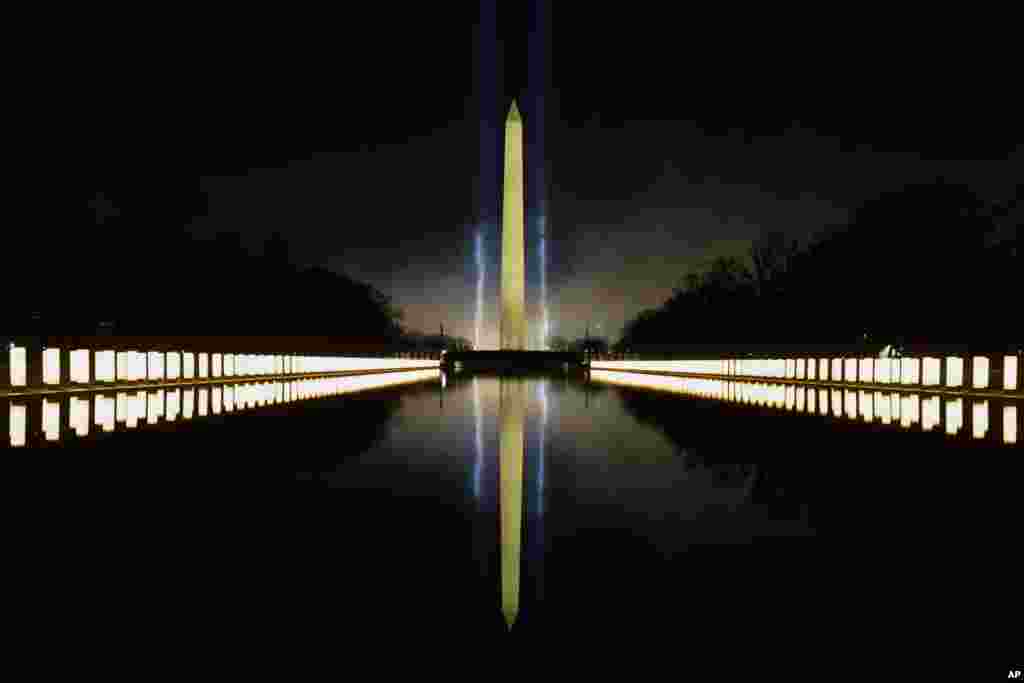 COVID-19 memorial lights are seen surrounding the Reflecting Pool and the Washington Monument in the background during the Celebrating America concert at the Lincoln Memorial in Washington, Jan. 20, 2021, after President Joe Biden's inauguration.