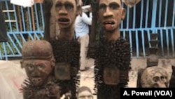 Original pieces and antique crafts sell for a song at the bustling Kinshasa art market.
