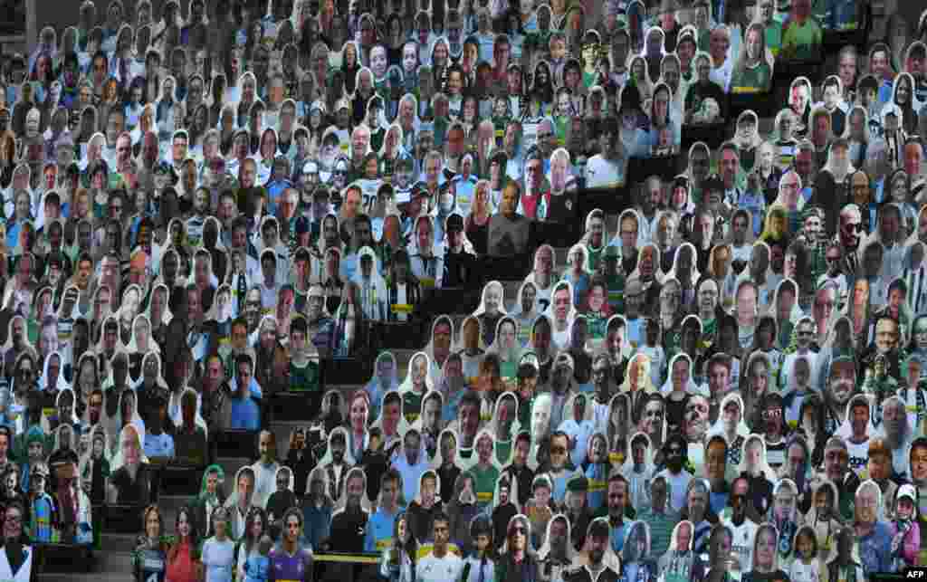 Cardboard cut-outs with portraits of Borussia Moenchegladbach's supporters are seen at the Borussia Park football stadium in Moenchengladbach, western Germany, amid the COVID-19 pandemic.
