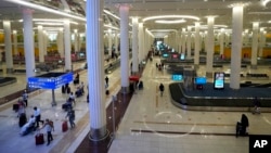 FILE - Passengers leave the baggage handling hall at the Dubai International Airport terminal 3, in Dubai, United Arab Emirates, on Oct. 25, 2022. The number of passengers at the world's busiest airport for international travel surged in 2023, beyond its total for 2019.