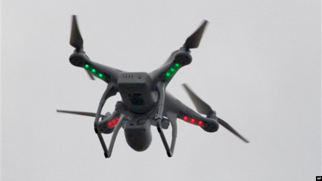 FILE - A drone hovers over the scene of an explosion that leveled two apartment buildings in the East Harlem neighborhood of New York, March 12, 2014.