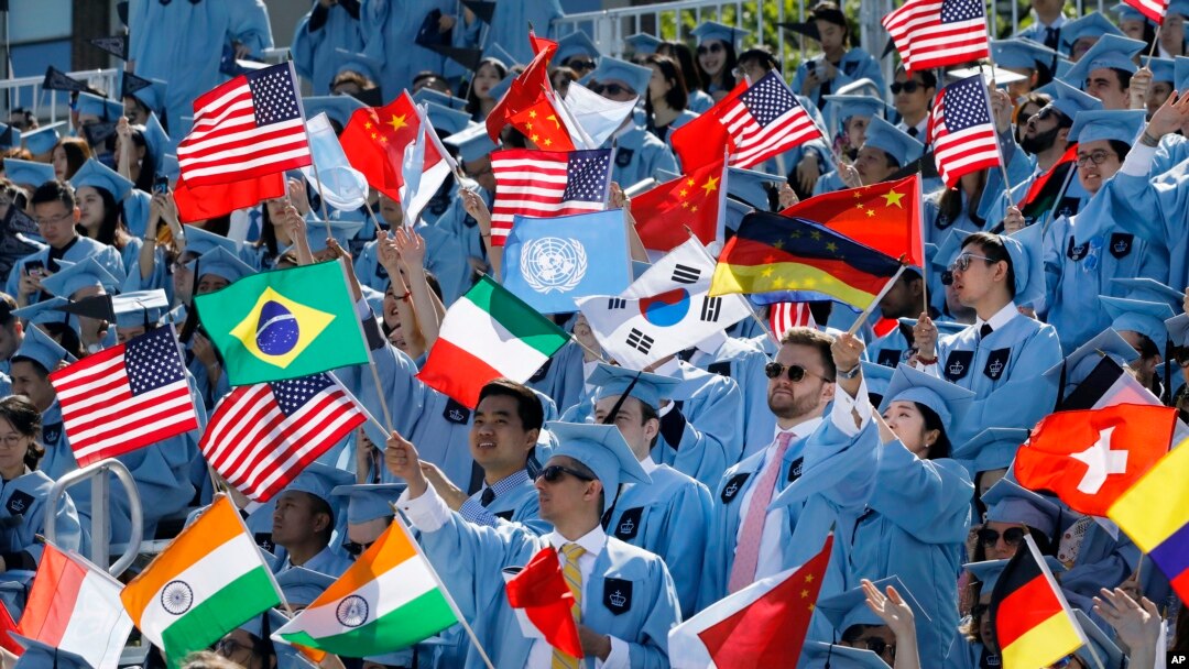 FILE - Columbia University students celebrate at the graduation ceremonies in 2019. A recent lawsuit claims Columbia and 15 others have worked together to limit financial aid to students. (AP Photo/Mark Lennihan)