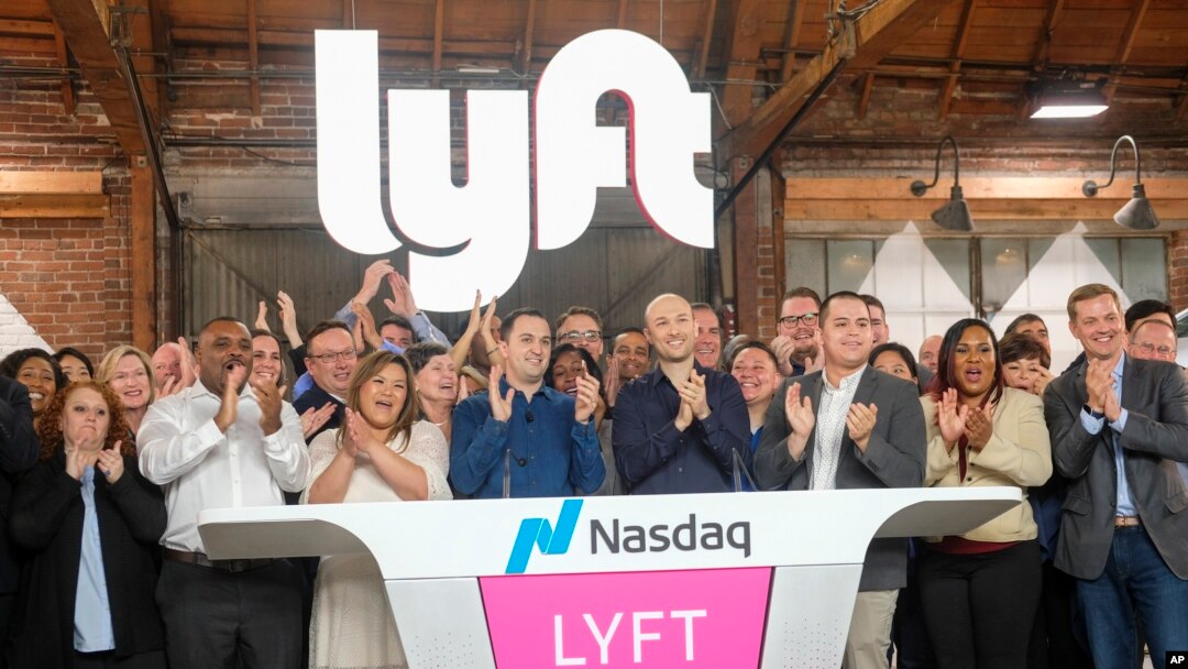 Lyft co-founders John Zimmer, center left, and Logan Green, center right, attend Lyft's IPO event in Los Angeles, California, March 29, 2019.