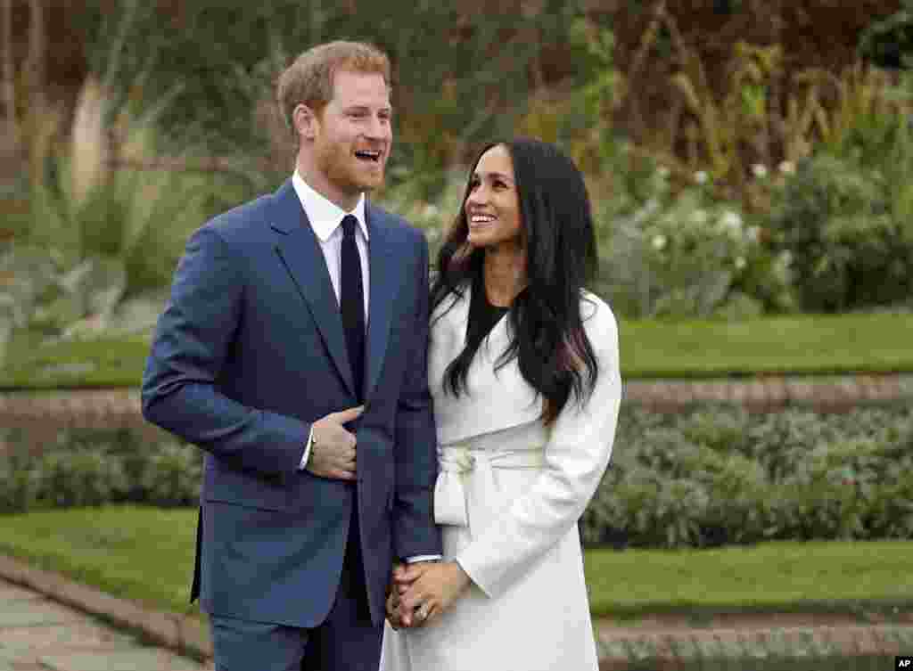 Britain's Prince Harry and his fiancé Meghan Markle pose for photographers during a photocall in the grounds of Kensington Palace in London. Britain's royal palace says Prince Harry and American actress Meghan Markle are engaged and will marry in the spring of 2018.