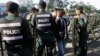 FILE - Riot police stand guard at a blocked street outside the supreme court in Phnom Penh, Cambodia, Nov. 16, 2017. The court ultimately dissolved the opposition Cambodia National Rescue Party, seen as another move by authoritarian Prime Minister Hun Sen to remove threats to his power ahead of elections next year.