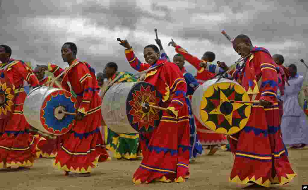 Members of the International Apostolic Ejuwel Jekenisheni Church dance, sing, pray, and play drums during a morning service at the open-air church on the outskirts of Harare, Zimbabwe.