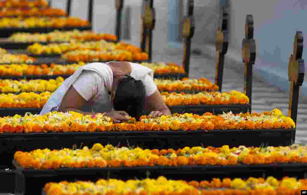 An Indian woman prays by a grave on All Souls' Day in Hyderabad, India.