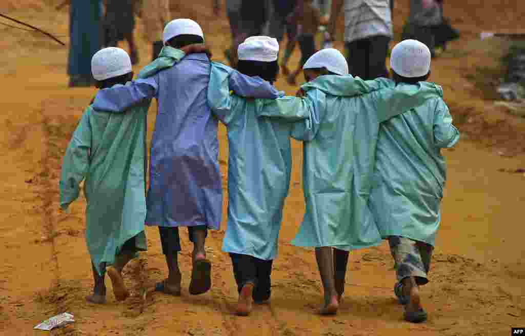Rohingya refugee children walk at Moynerghona refugee camp in the Bangladeshi district of Ukhia.