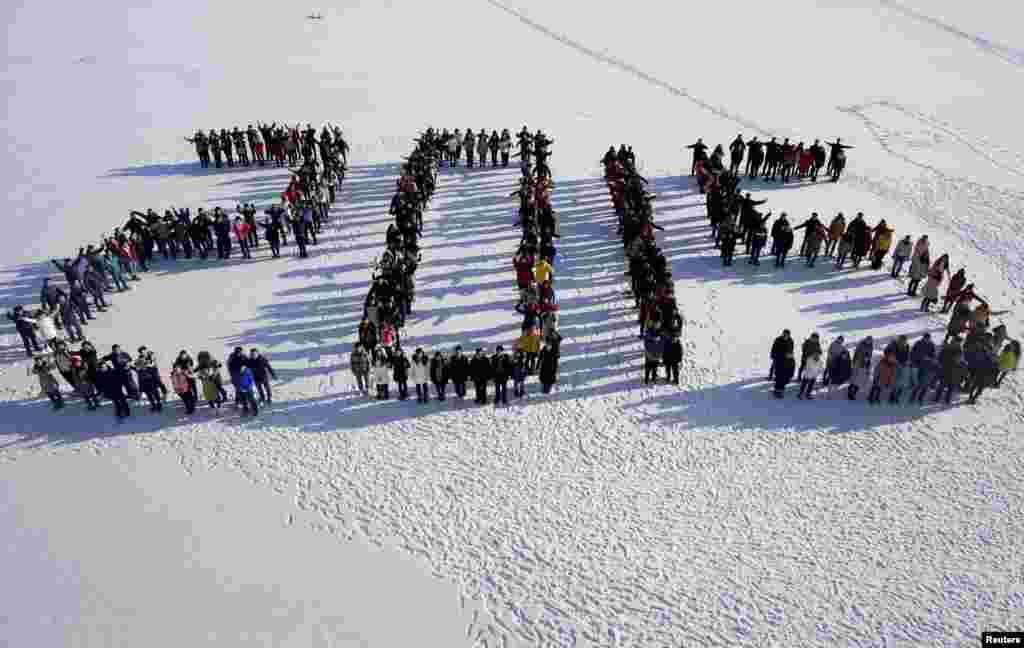 Students form "2015" standing on snow to welcome the upcoming New Year at Shenyang Agriculture University in Shenyang, Liaoning province, China.