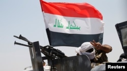 A member of Iraqi security forces gestures near Falluja, Iraq, May 31, 2016. 