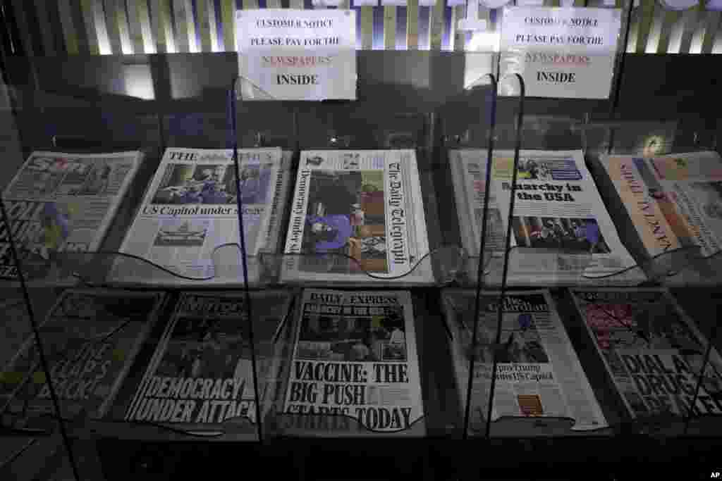 British national newspapers, with front pages reporting on the mob loyal to President Donald Trump storming the U.S. Capitol, are displayed for sale outside a store in London.
