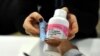 FILE - A woman gets antiretroviral drugs at the Chris Hani Baragwanath Hospital, South Africa's largest public hospital, in Soweto.