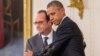 President Barack Obama and French President Francois Hollande embrace during a joint news conference in the East Room of the White House in Washington, Nov. 24, 2015.
