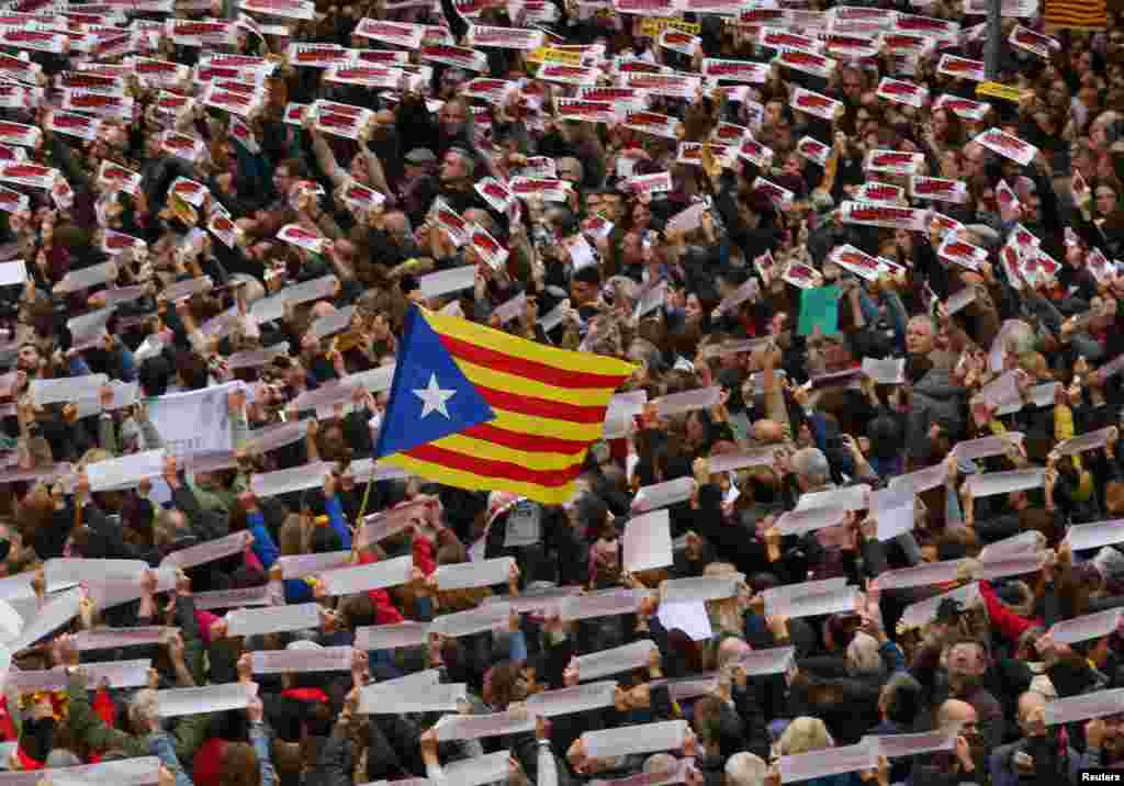 Protesters hold banners reading "Freedom Political Prisoners, We are Republic" as they gather in Sant Jaume square at a demonstration during a partial regional strike in Barcelona, Spain.